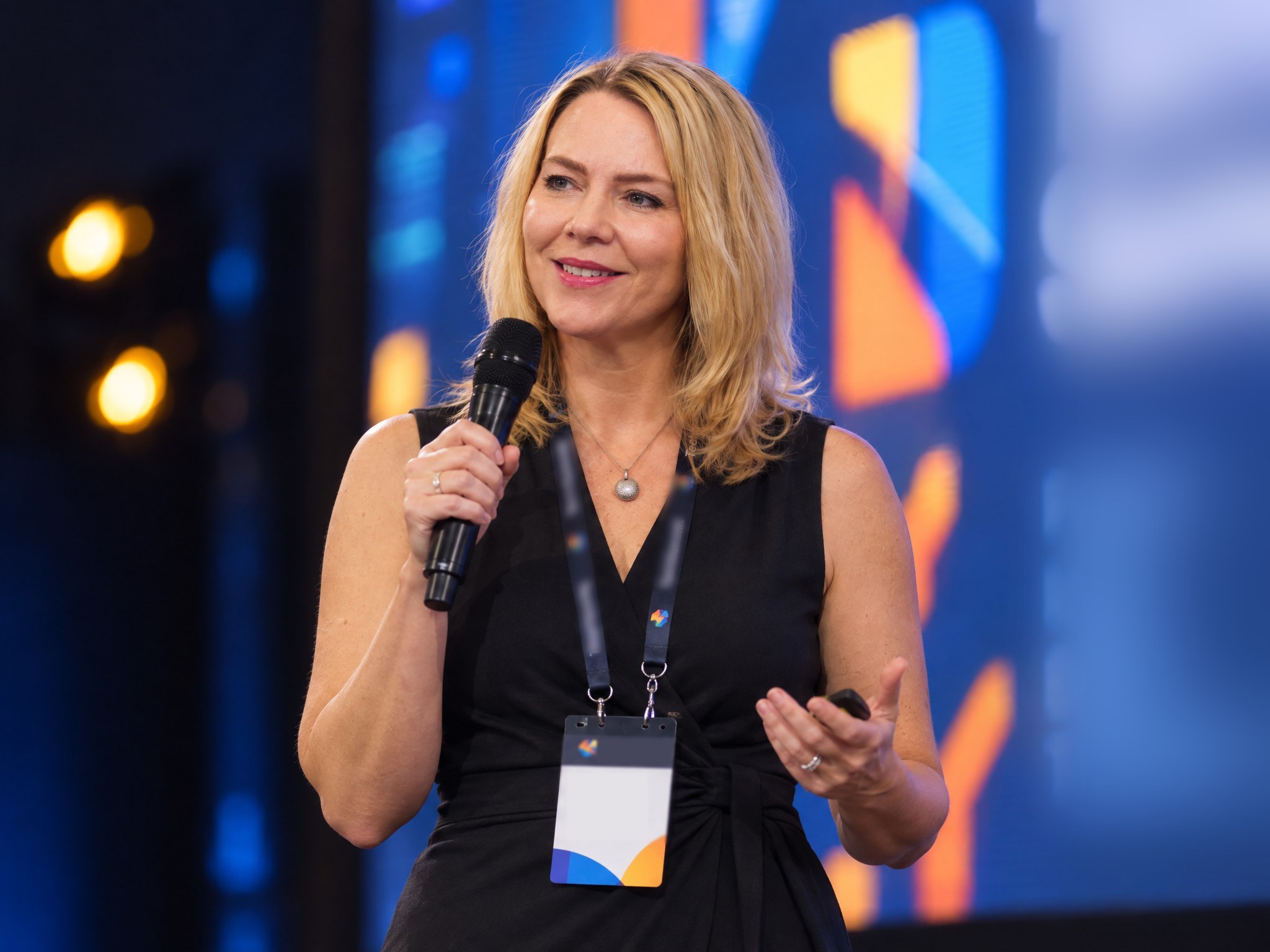 Monika Gietz speaking on stage at a technology event